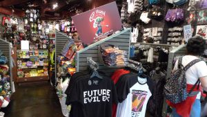An image of the interior of a Hot Topic retail store with various clothing that commodify various subcultures.